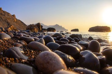 Sunrise and sunset on the stone seashore. landscape in...
