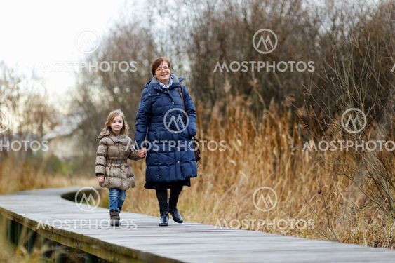 Little girl and her grandmother taking a walk