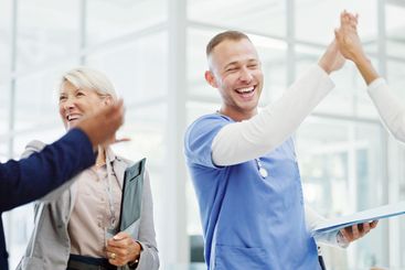 Doctors, high five and celebration with team at clinic...