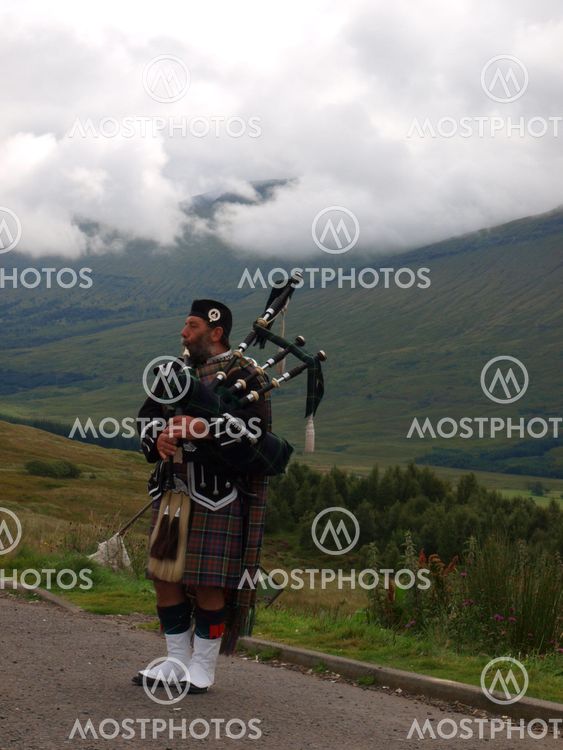 A Scot playing pipes in Glencoe