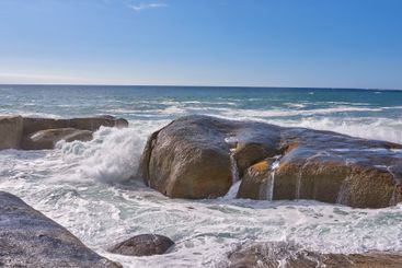 Rocks, travel and beach with waves, vacation and view...