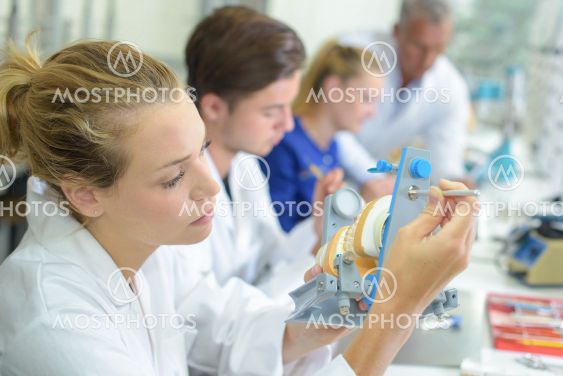 Woman working on false teeth