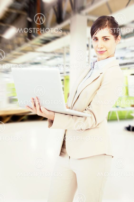 Composite image of confident young businesswoman with laptop