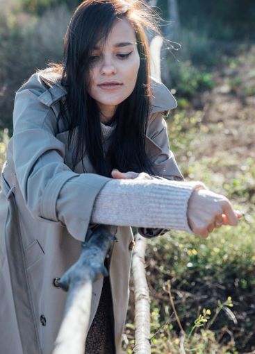 Beautiful fashionable brunette woman in gray autumn coat