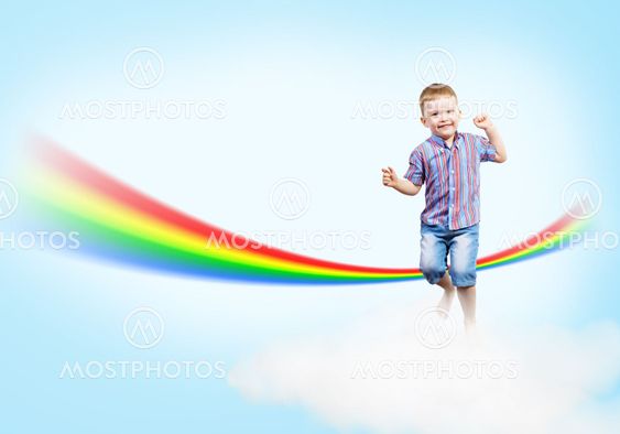 boy jumping on clouds and a rainbow
