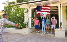 Happy diverse group of friends greeting biracial male americ