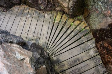 Wooden walkway perfectly fitting between rocks.