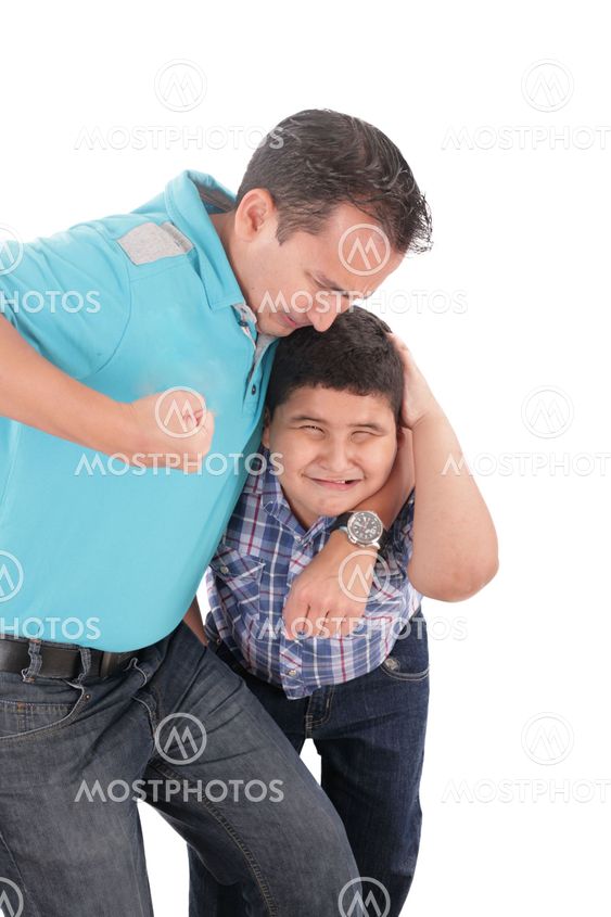 Young boy being aggressively held up by his father