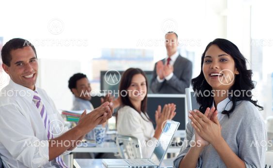 Businessteam applauding a colleague after a presentation