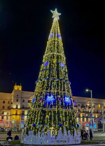 beautifully decorated Christmas tree on the square near...