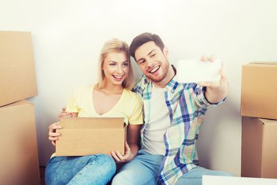 couple with taking smartphone selfie and moving