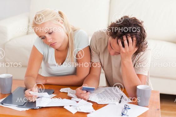 Unhappy couple listing expenses