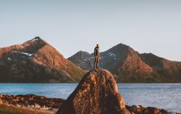 Travel in Norway outdoor man raised arms active healthy life