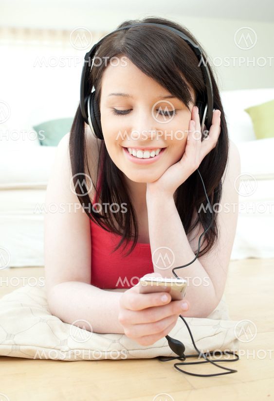 Radiant woman listening music with headphones on
