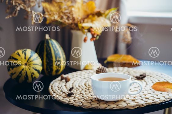 Hot steaming cup of coffee, tea with autumn bouquet,...