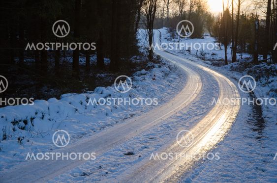 Sunset by an icy country road