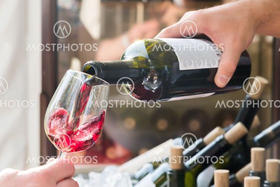 red wine being poured into a glass close-up