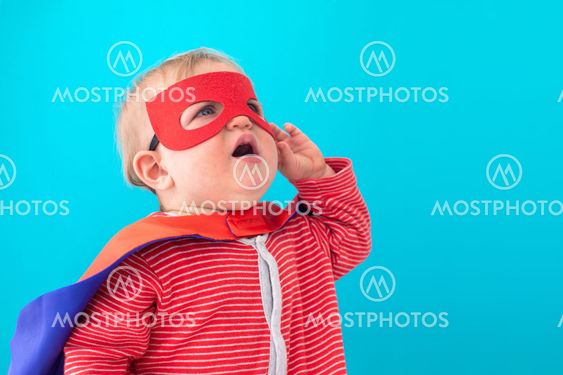 Baby superhero looking away
