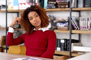 Thinking, creative and business woman in office for...