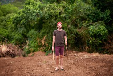 Portrait, man and hiking outdoor with stick for travel,...