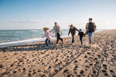 family walking together on seashore