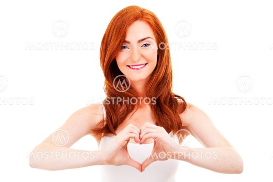 Smiling woman forming a heart with her hands