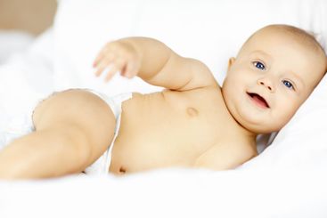 Baby, boy and portrait on sheet, home and smile with...