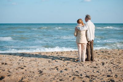 senior couple hugging on seashore