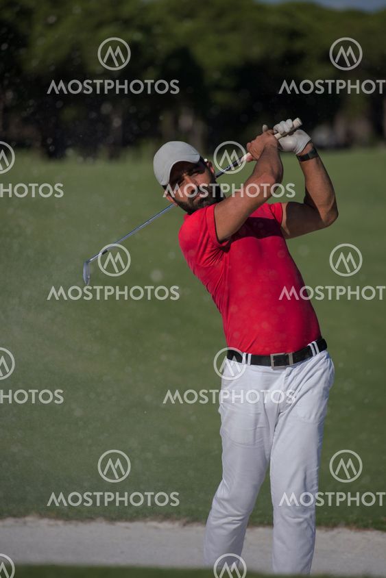 golfer hitting a sand bunker shot