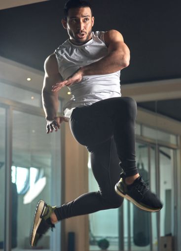 Workout, jumping and health with man in gym for...