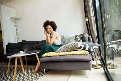 Attractive young woman working on laptop at home