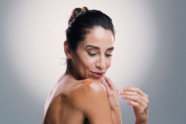 Smile, woman and skincare beauty in studio for anti...