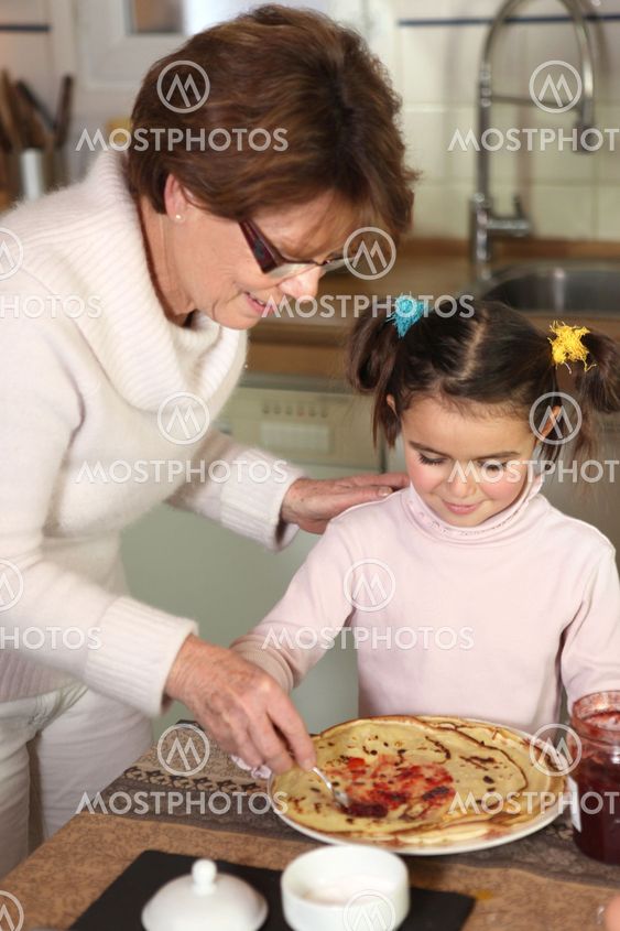 Grandmother serving pancakes