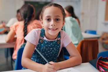 Writing, student and education with girl in classroom...