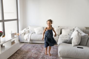 Little 5s girl having fun alone in living room