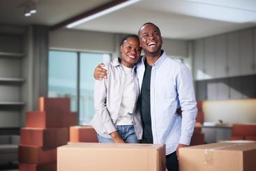 Happy Young Couple Moving Boxes