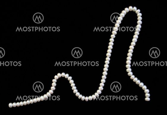 White pearls on the black silk