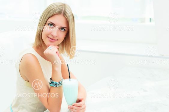 Portrait of a cute woman in a city cafe