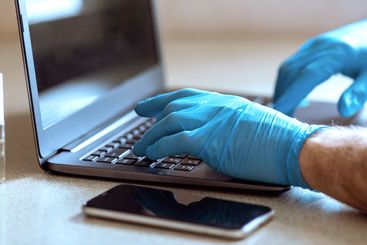 Man Using Laptop Working On Laptop During Quarantine At...