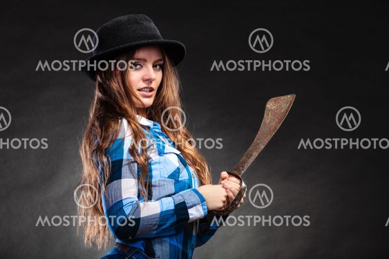 Pretty strong woman in hat holding machete.