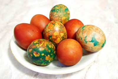 Colorful Easter Eggs On White Plate Placed By Heap