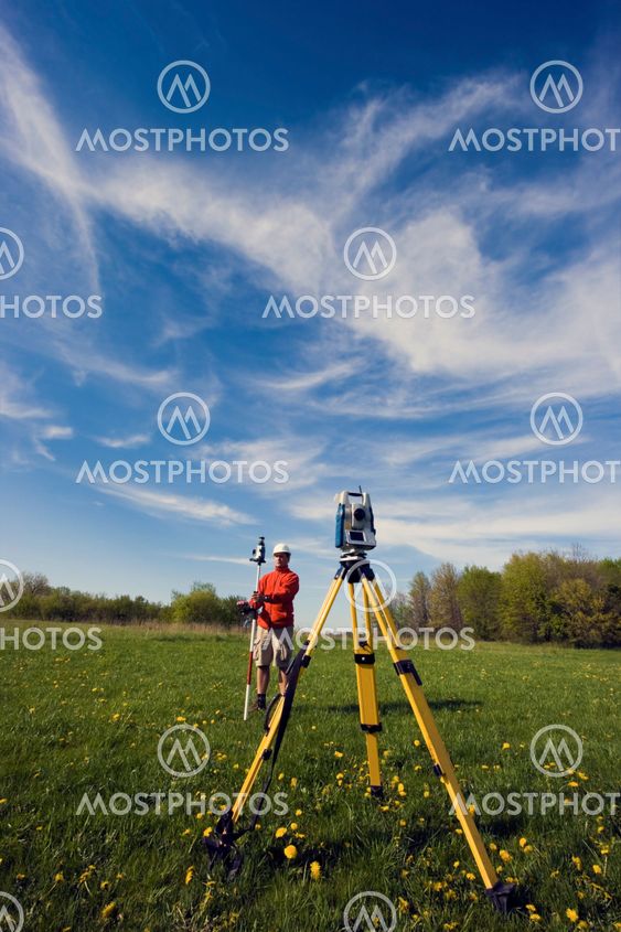 Land Surveyor working with robotic station