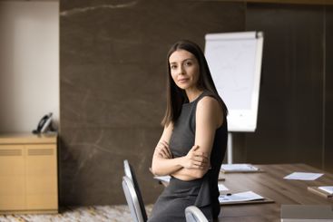 European businesslady in casual dress posing in meeting...