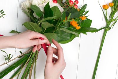 Female florist making beautiful bouquet at flower shop