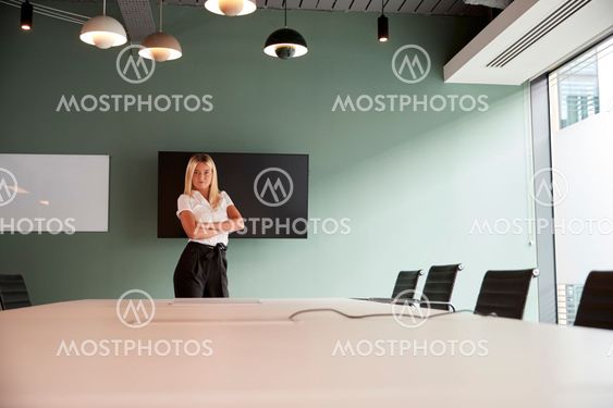 Portrait Of Young Businesswoman Standing By Boardroom...