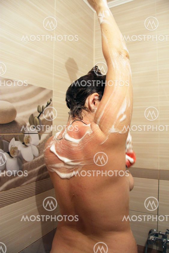 Attractive woman taking shower in bath room