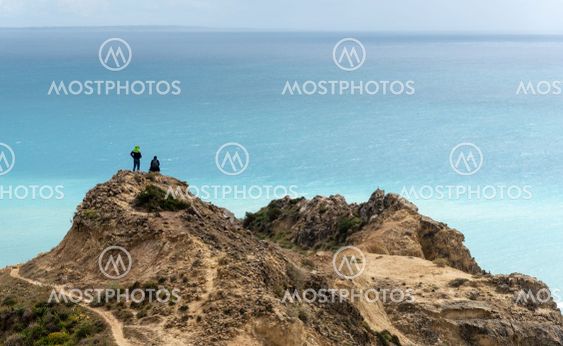 Unrecognized family standing at the edge of a cliff...