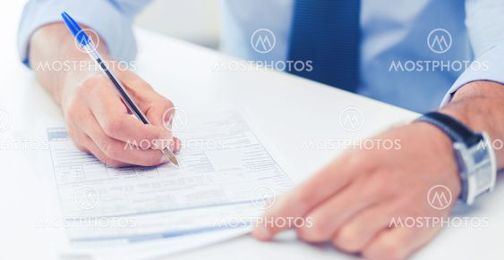 man filling tax form