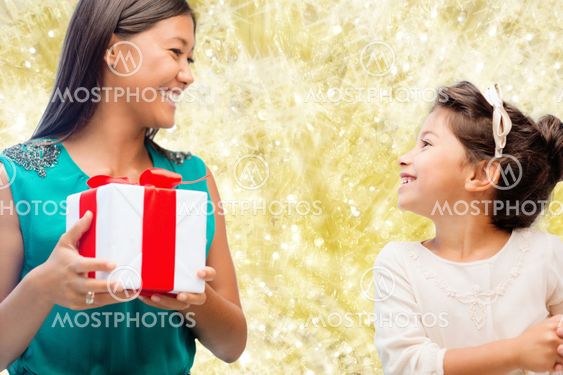 happy mother and little girl with gift box