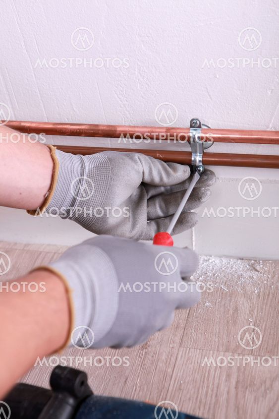 Plumber installing copper pipe